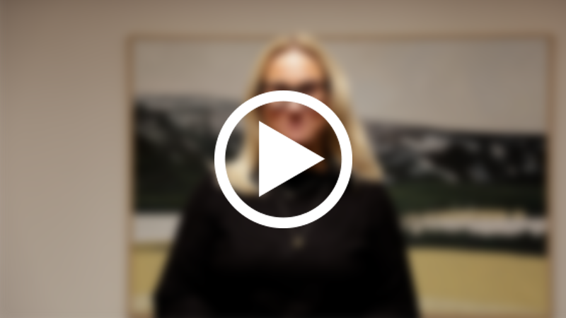 Skärmklipp från video med kvinna i oskärpa och en skarp playsymbol.