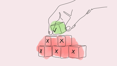 Hand staplar klossar med kryss och bock.