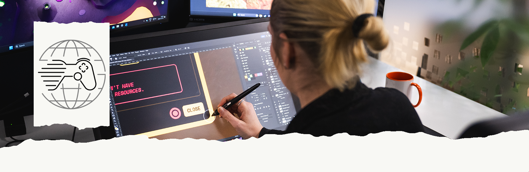 Woman in front of computer creating a game