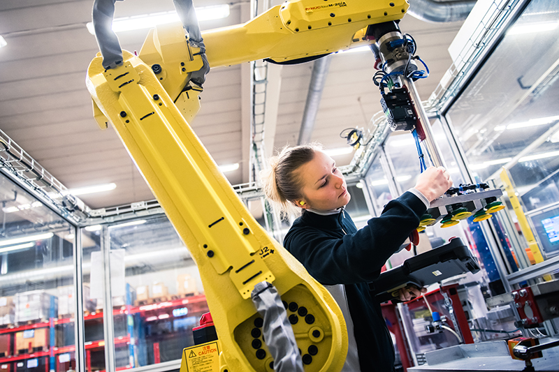 Från industrin. En kvinna och en robot