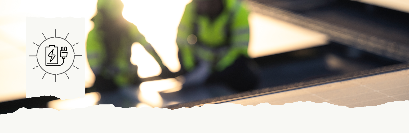 Two workers on a roof surrounded by solar panels